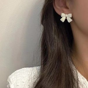 White bow earrings